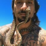 Australian Man Surfs With Python Around His Neck, Fined $1,500
